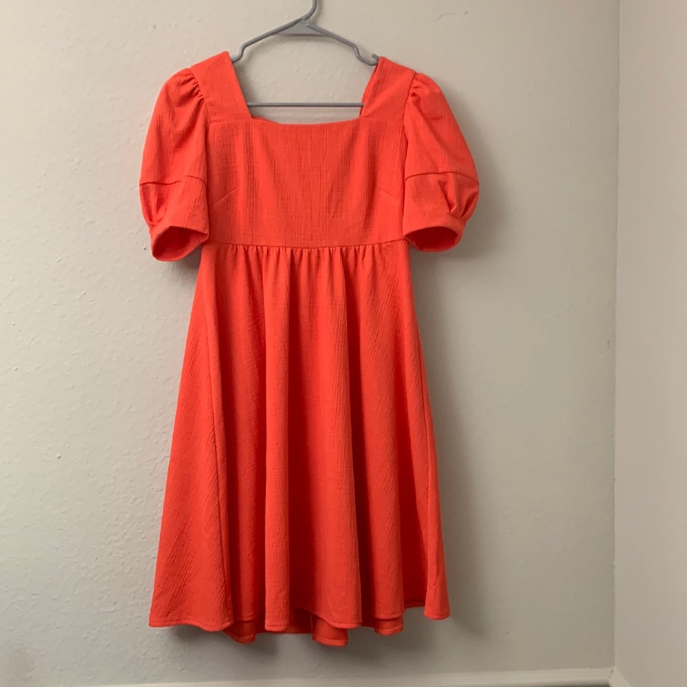 Woman’s small bright coral dress